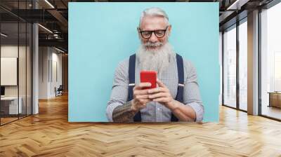 Happy senior hipster man using mobile phone outdoors in the city - Focus on face Wall mural