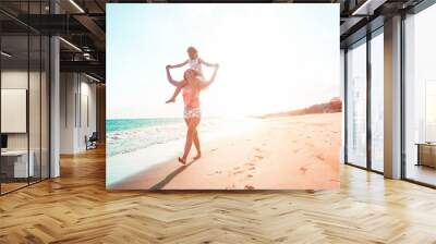 Mother and daughter having fun on tropical beach Wall mural