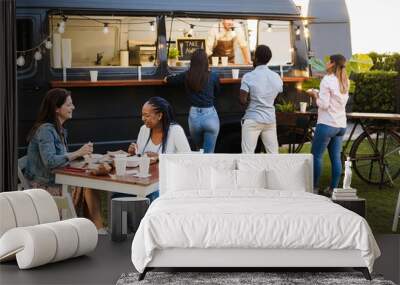 Multiracial people having fun eating at food truck restaurant outdoor - Focus on senior african woman face Wall mural