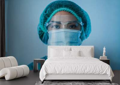 Portrait of young latin nurse work inside hospital during coronavirus period - Woman medical worker on Covid-19 outbreak wearing face protective mask Wall mural