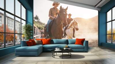 Real people riding horses inside corral Wall mural