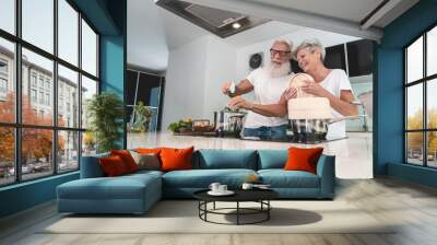 Senior couple cooking healthy meal at home in the kitchen - Elderly and joyful lifestyle - Focus on hands - food nutrition concept Wall mural