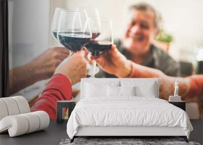 Senior friends cheering with red wine glasses at restaurant lunch Wall mural