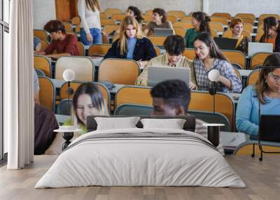 Young multiethnic students working with tablets inside classroom at school university - Focus on center girl face Wall mural