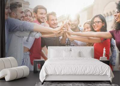 Young students stacking hands outdoor in college campus Wall mural