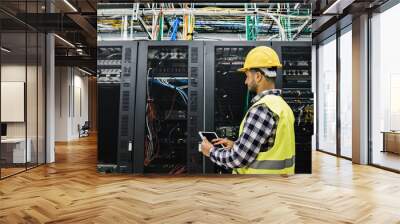 Young technician man working inside big data center room - Focus on face Wall mural