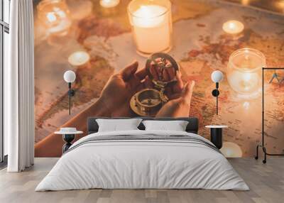 Young woman planning world tour with vintage travel map - Traveler girl using compass with candles in background - Wanderlust, globetrotter trends and holiday concept - Focus on right hand Wall mural