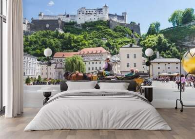 Tourists sightseeing in horse carriage in Salzburg, Austria Wall mural