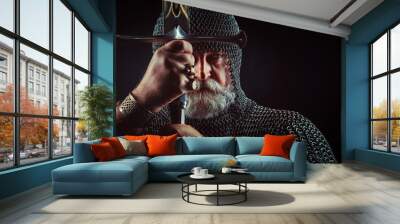 Powerful bearded knight with the sword on the dark background Wall mural