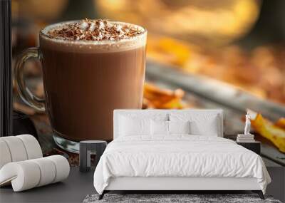 hot chocolate or coffee in a mug during autumn fall time surrounded by nature and dried up orange maple leaves to signify the changing of seasons. Closeup of hot chocolate with whipped cream Wall mural