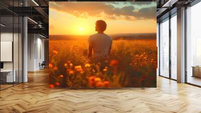 The guy looks at the sunset on the field. Spring. Warm lighting. Wildflowers. Wall mural