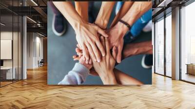 close up of stacked human hands showing working together to build a business. Wall mural