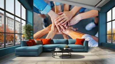 close up of stacked human hands showing working together to build a business. Wall mural