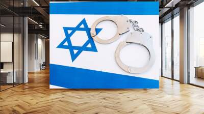 israel flag and police handcuffs. The concept of crime and offenses in the country. concept of crime in the state or government of the country. Wall mural