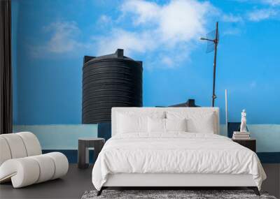 Water tank on the roof over blue sky Wall mural