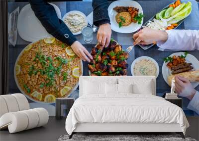 happy muslim family eating togther Wall mural