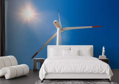 Wind turbines  against a blue sky generating electricity Wall mural