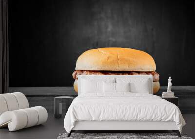 Plain beef burger on wooden table isolated on black background Wall mural