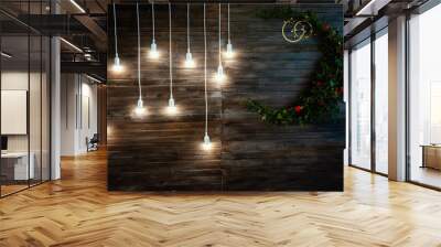 Glowing light bulbs hang on a long cord against the background of a wooden wall Wall mural