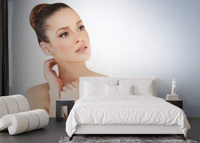 Beautiful face of young adult woman with clean skin Wall mural