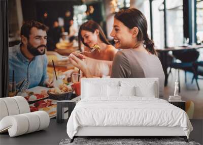 Group of Happy friends having breakfast in the restaurant Wall mural