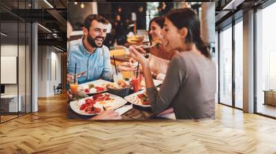 Group of Happy friends having breakfast in the restaurant Wall mural