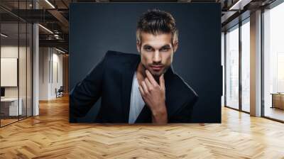 portrait of handsome man in a studio on a dark background Wall mural