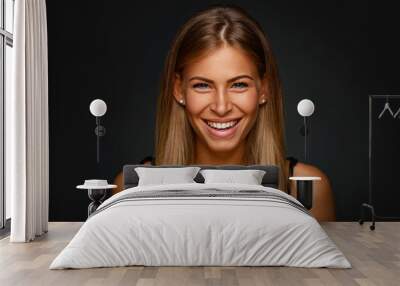 Portrait of young smiling blonde in studio Wall mural