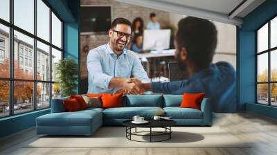 Two men handshake in the office Wall mural