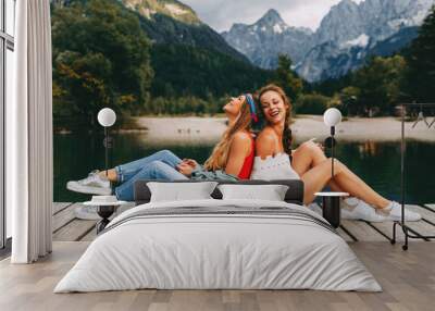 Two young tourist women have fun on the lake Wall mural