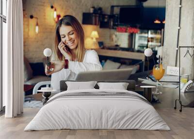 Young businesswoman talking on the phone and checking the time Wall mural