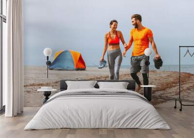 Young couple enjoying the beach after workout Wall mural