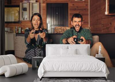 Young Couple Playing Video Game Together at Home Wall mural