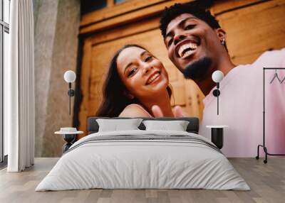 Young happy couple taking a selfie on the street Wall mural