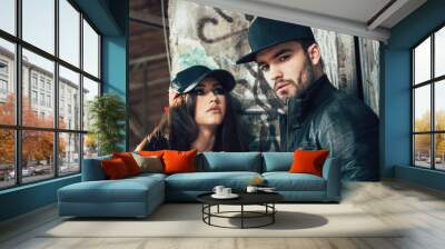 Young urban couple posing selective focus on man Wall mural