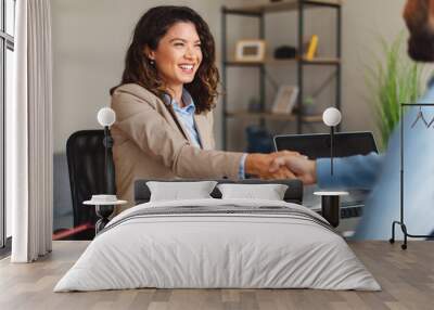 Young woman signing contracts and handshake with a manager Wall mural