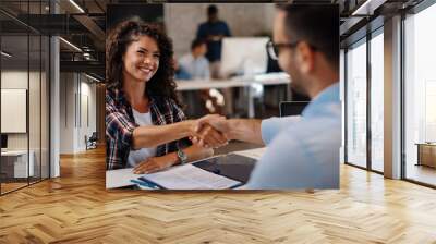 young woman signing contracts and handshake with a manager Wall mural