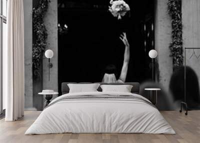 black and white image of bride throwing the bouquet. wedding background Wall mural