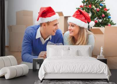 Happy couple is celebrating Christmas in their new home. Wall mural