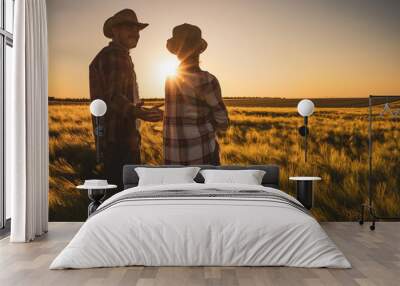 Man and woman are working together in partnership. They are cultivating barley. Wall mural