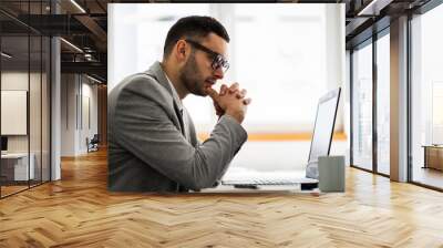 Young businessman is working in office. Wall mural