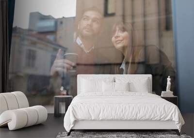 Two young professionals looking through the window Wall mural