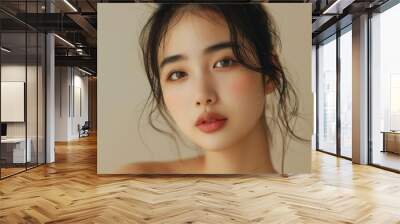 Beautiful young Asian woman with clean fresh skin on beige background face care facial treatment cosmetology beauty and spa Asian women portrait Wall mural