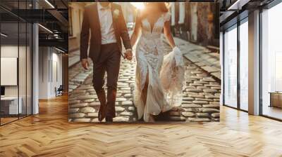 Bride and groom walking down a charming cobblestone street, love and joy of their wedding day Wall mural