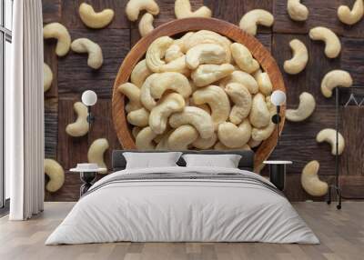 cashew nuts peeled raw in wooden bowl, top view. Wall mural