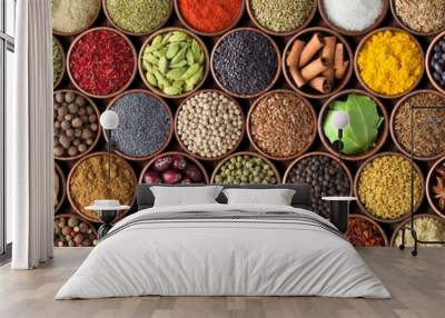 Different seasonings in cups. Spice background on the table Wall mural