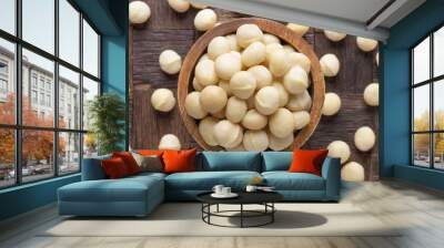 macadamia nuts peeled in wooden bowl, top view. Wall mural