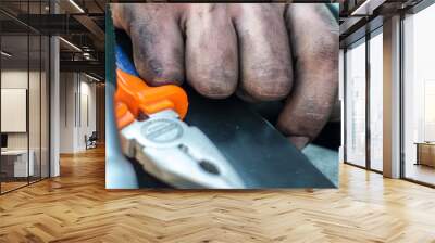 Mechanic repairing car with dirty hands in oil Wall mural