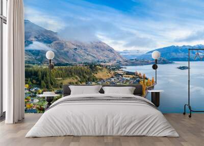 Small town surrounded by yellow autumn trees on a shore of pristine lake with mountains on the background. Wanaka, Otago, South Island, New Zealand Wall mural