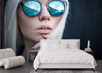 Beautiful blonde girl in sunglassses outside Wall mural